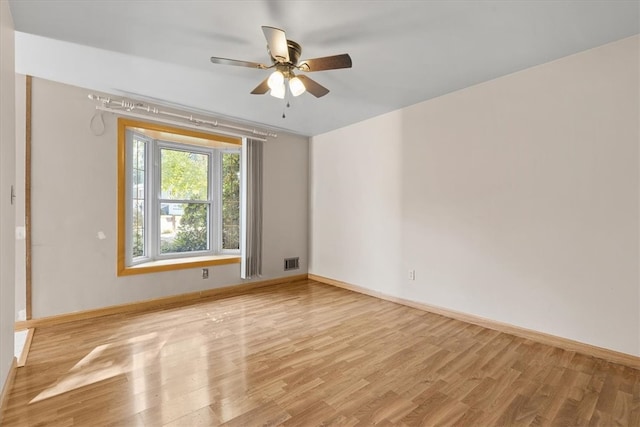 spare room featuring ceiling fan and light hardwood / wood-style floors