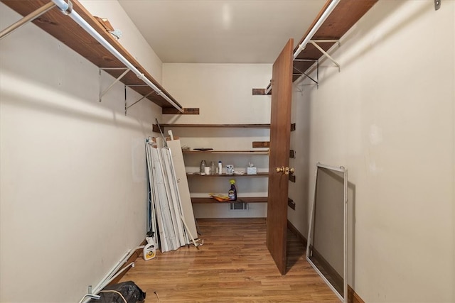 spacious closet featuring light hardwood / wood-style flooring