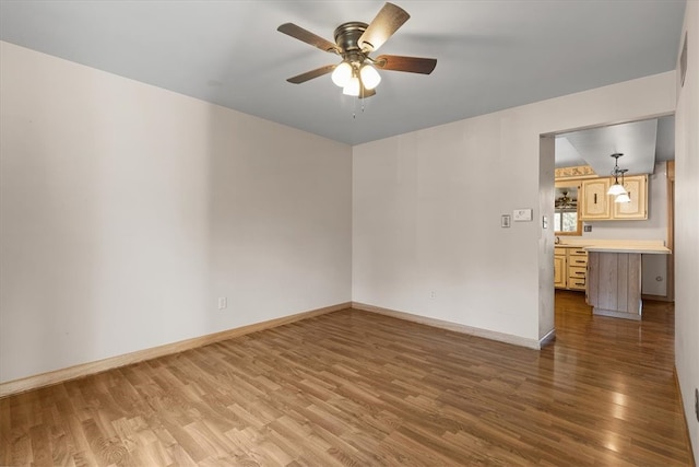 unfurnished room featuring ceiling fan and hardwood / wood-style floors