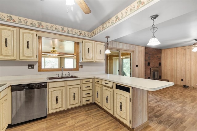 kitchen with stainless steel dishwasher, sink, kitchen peninsula, a healthy amount of sunlight, and decorative light fixtures