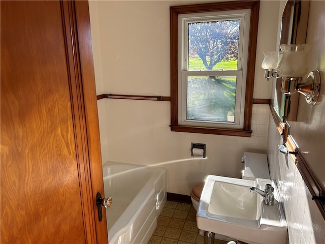 bathroom featuring sink and a bath