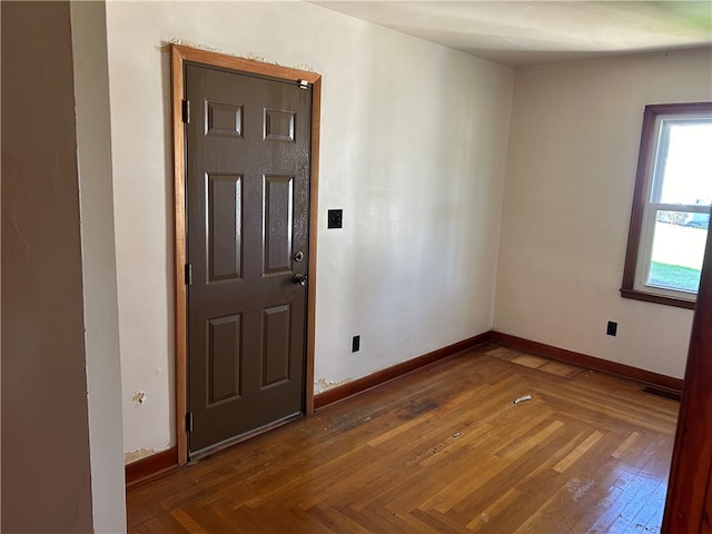 foyer entrance featuring dark parquet floors