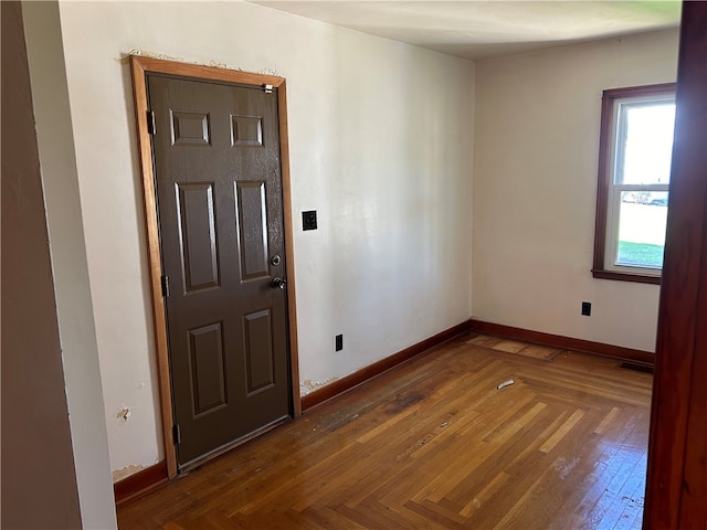 unfurnished room with dark parquet floors