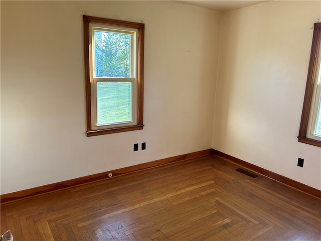 unfurnished room with parquet flooring