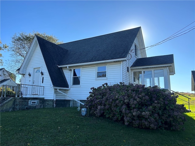 view of side of property with a lawn