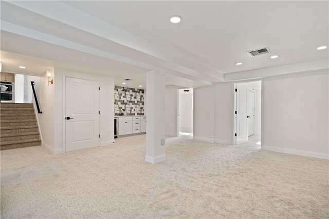 1205 Curry Rd, Sewickley Twp, PA 15083 - unfurnished living room featuring light carpet, recessed lighting, stairway, baseboards, and bar