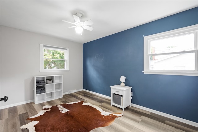 empty room featuring hardwood / wood-style floors and ceiling fan