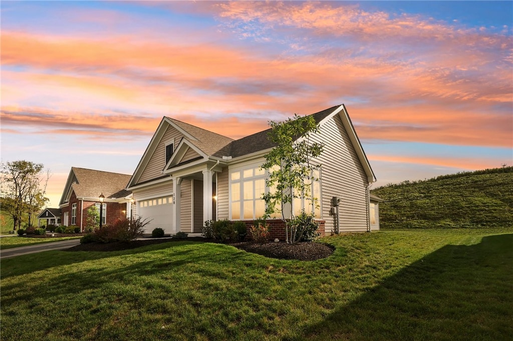 view of front of house with a yard and a garage