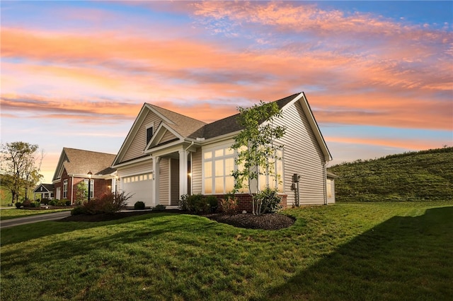 view of front of house with a yard and a garage