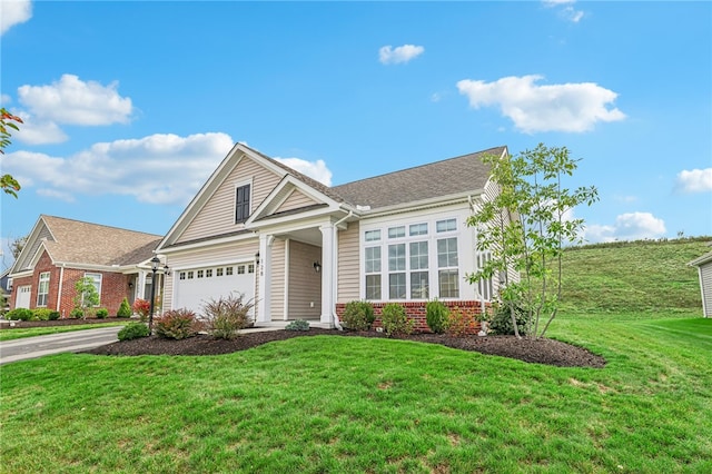 view of front of home with a garage and a front lawn