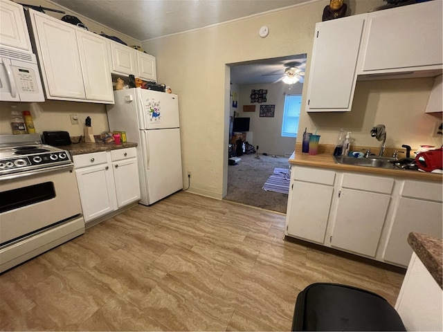 kitchen with white appliances, ceiling fan, sink, and white cabinetry