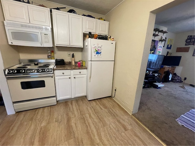 kitchen with light wood-type flooring, white appliances, white cabinetry, and a textured ceiling