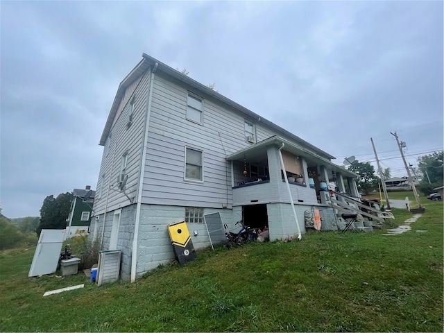 rear view of house with a garage and a yard