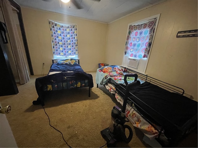 bedroom with carpet floors, ornamental molding, and ceiling fan