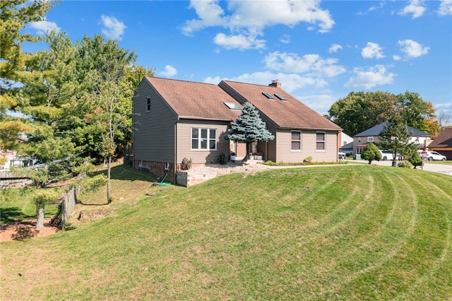 rear view of property featuring a yard