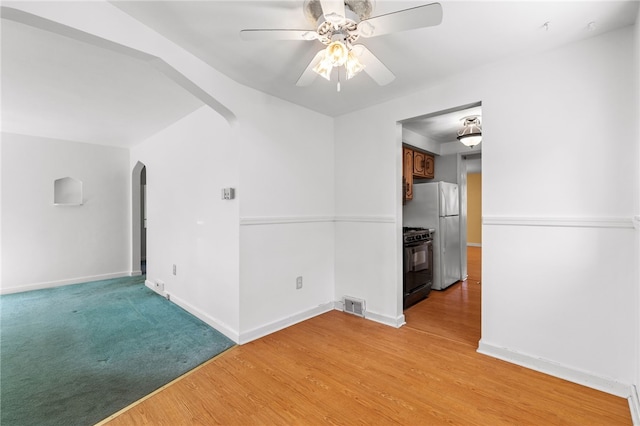 unfurnished room featuring ceiling fan and light hardwood / wood-style flooring