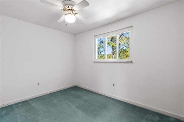 unfurnished room featuring dark carpet and ceiling fan