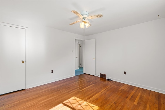 spare room featuring wood-type flooring and ceiling fan