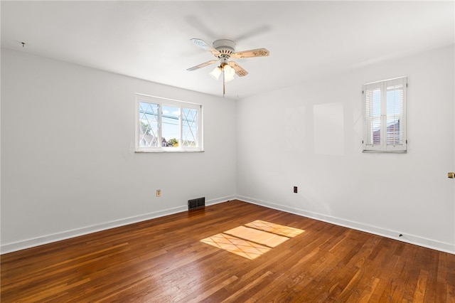 spare room with hardwood / wood-style floors and ceiling fan