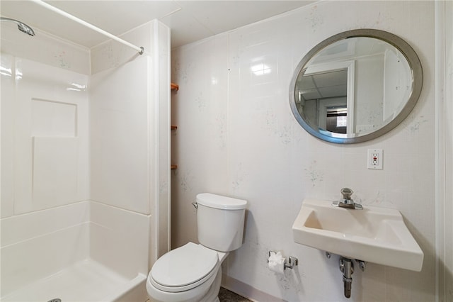 bathroom with sink, walk in shower, toilet, and tile walls