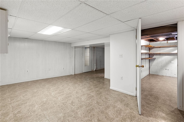 basement with a paneled ceiling