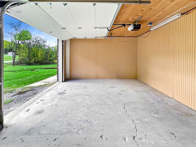 garage with a garage door opener and a lawn