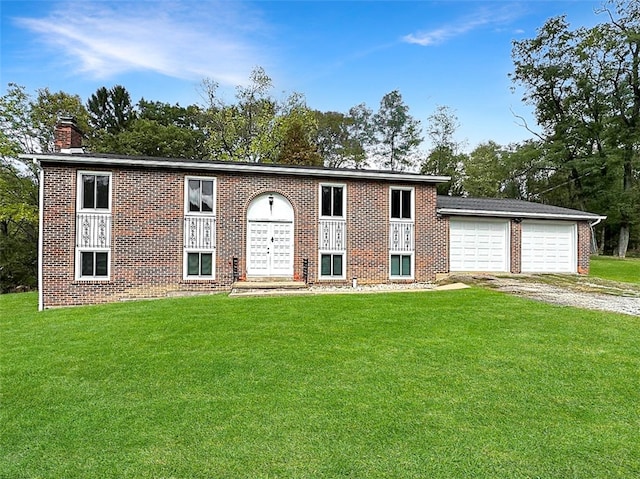 raised ranch with a front yard and a garage