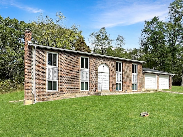 bi-level home featuring a front lawn and a garage