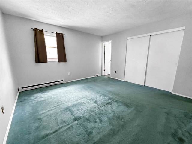 unfurnished bedroom with carpet floors, a closet, a baseboard heating unit, and a textured ceiling