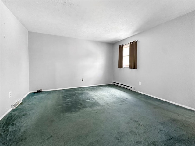 empty room featuring dark colored carpet, a baseboard heating unit, and a textured ceiling