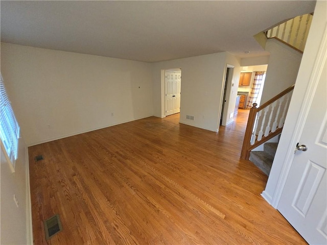 empty room with light hardwood / wood-style flooring