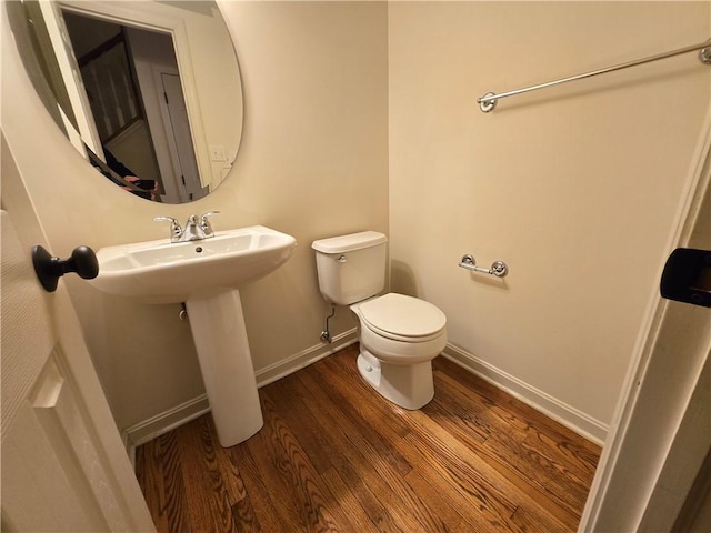 bathroom featuring sink, toilet, and hardwood / wood-style floors