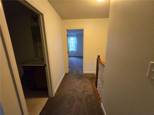 hallway featuring dark carpet