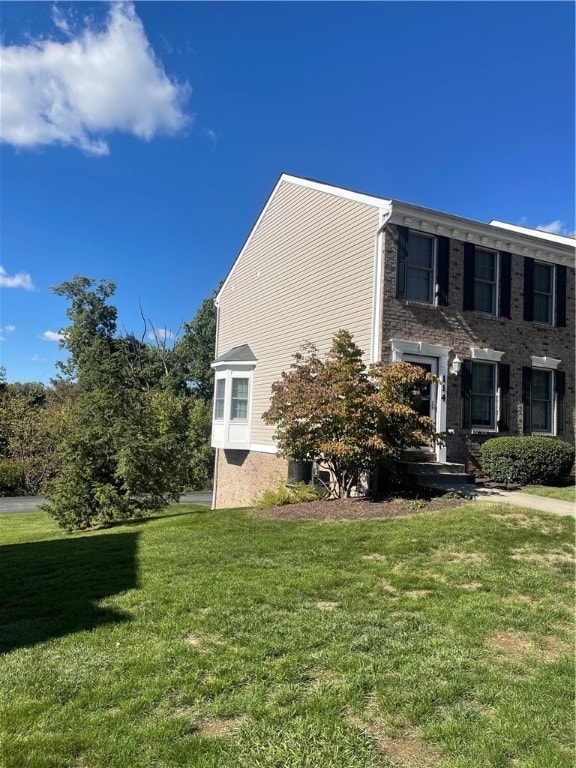 view of side of property with a lawn