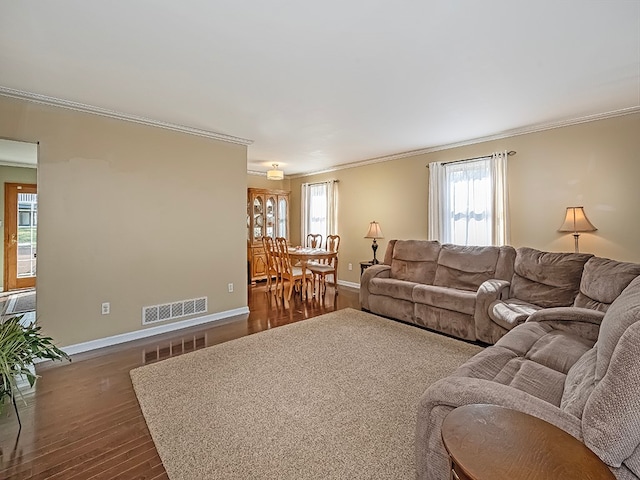 living room featuring ornamental molding and dark hardwood / wood-style flooring