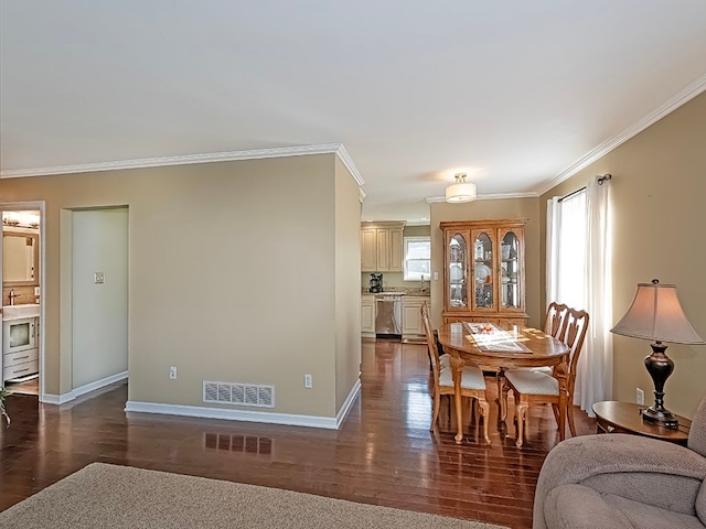 dining area featuring crown molding, dark wood-type flooring, and a healthy amount of sunlight