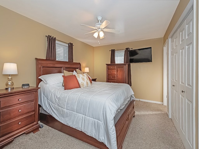 carpeted bedroom featuring a closet and ceiling fan