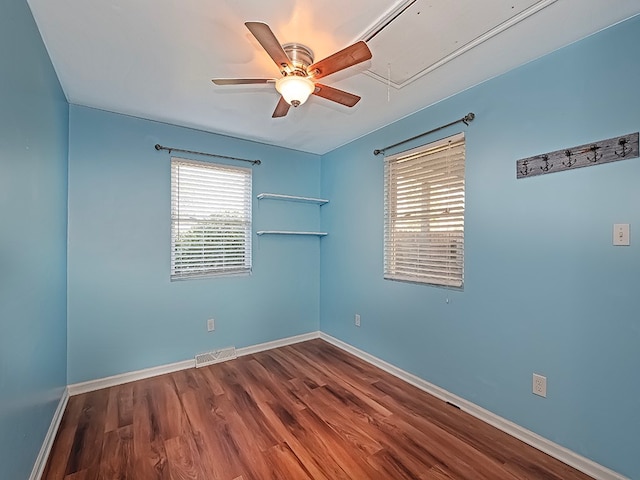 spare room featuring hardwood / wood-style flooring and ceiling fan