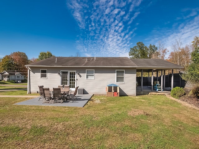 rear view of house featuring a patio and a yard