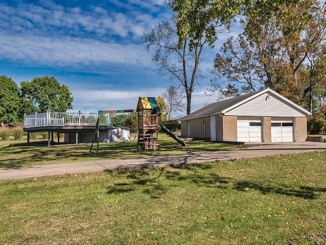 exterior space with a playground, a garage, an outbuilding, and a wooden deck