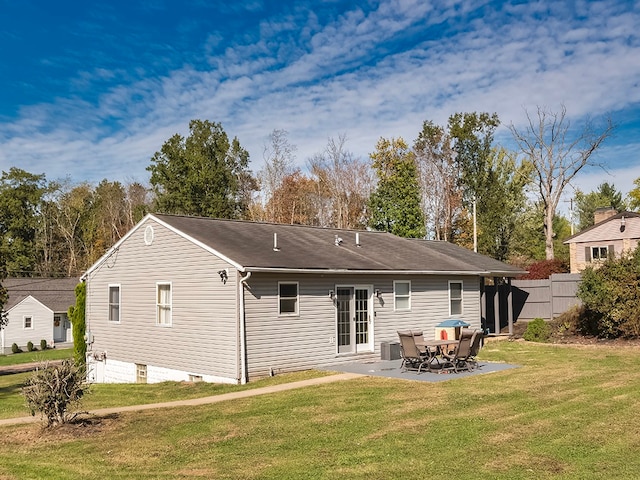 back of house featuring a yard and a patio