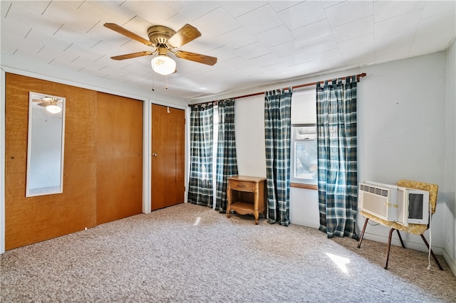 unfurnished bedroom featuring multiple closets, a wall mounted air conditioner, carpet, and ceiling fan