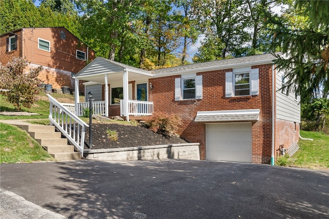 view of front of home with a garage and a porch