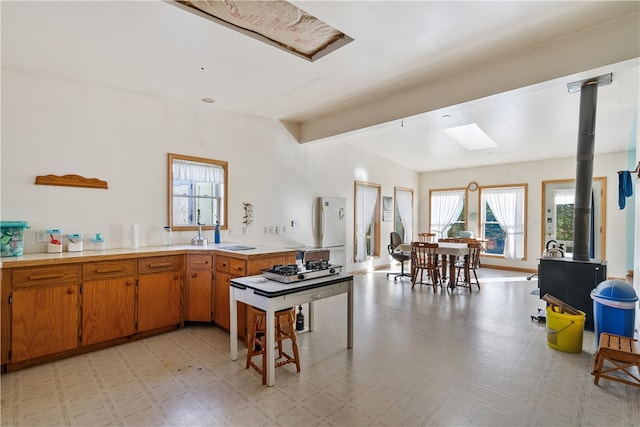 kitchen with a skylight and beamed ceiling