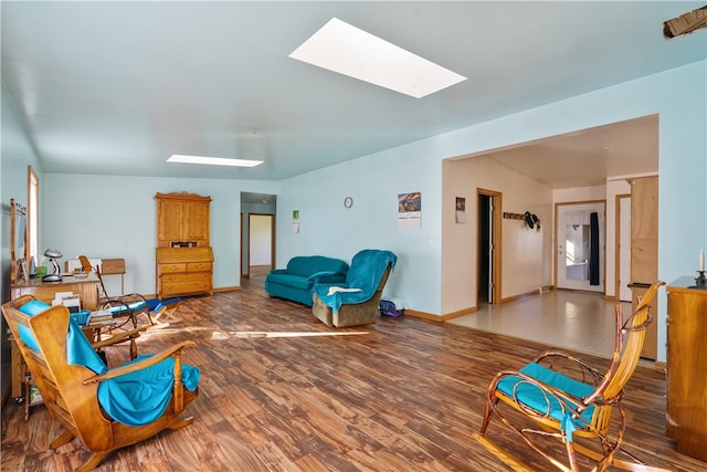 living room featuring a skylight and hardwood / wood-style floors