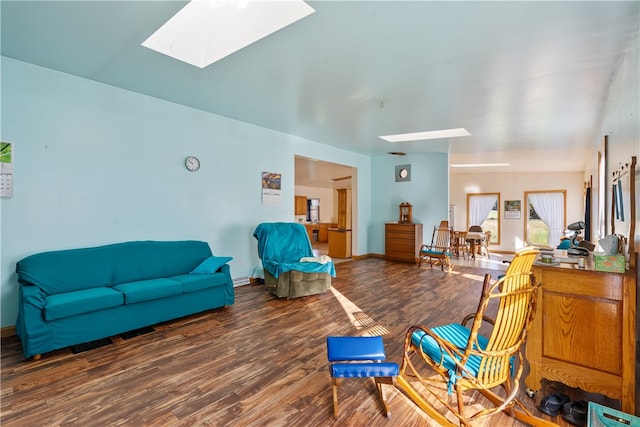 living room featuring a skylight and dark hardwood / wood-style floors