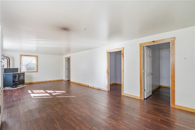 unfurnished living room featuring dark hardwood / wood-style flooring