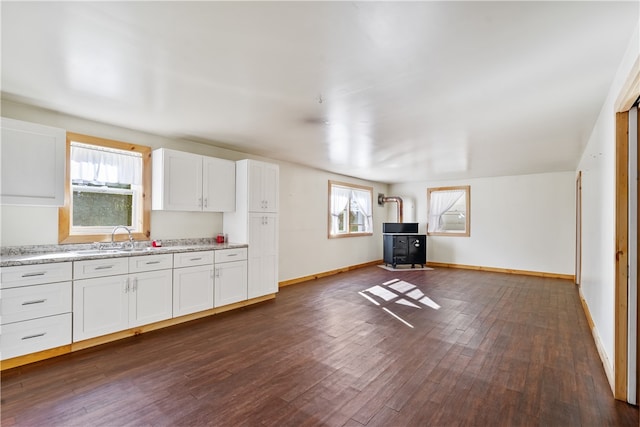 kitchen with plenty of natural light, dark wood-type flooring, and white cabinets