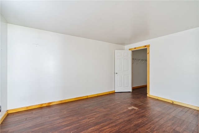 unfurnished room with dark hardwood / wood-style flooring