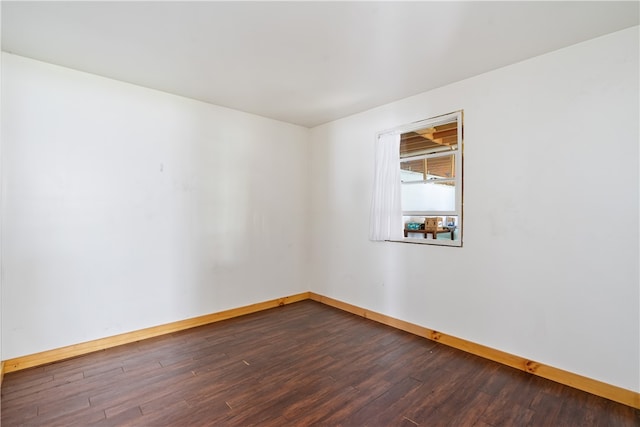 empty room featuring dark wood-type flooring